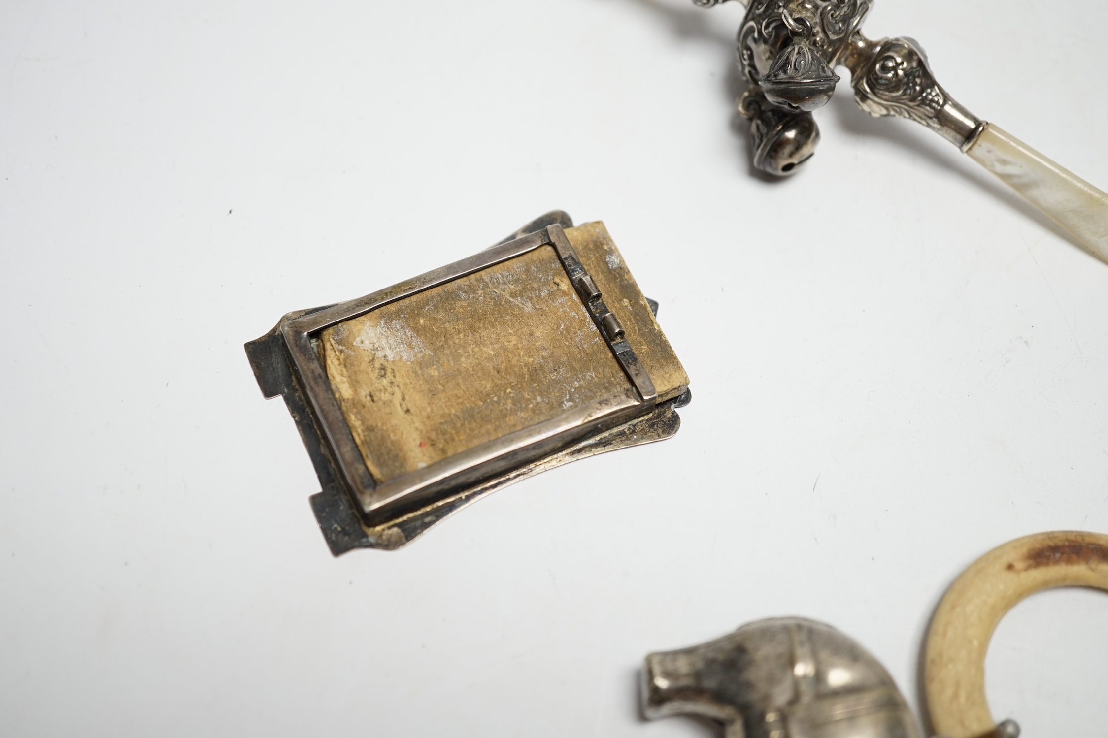 An Edwardian silver and mother of pearl child's rattle, 11cm, together with a miniature white metal photograph frame and a plated child's rattle.